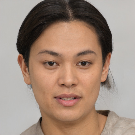 Joyful asian young-adult female with short  brown hair and brown eyes