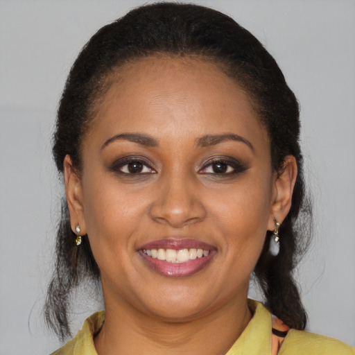 Joyful latino adult female with medium  brown hair and brown eyes