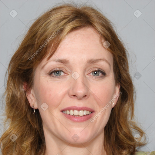 Joyful white adult female with long  brown hair and green eyes