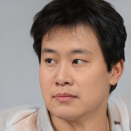 Neutral asian young-adult male with short  brown hair and brown eyes
