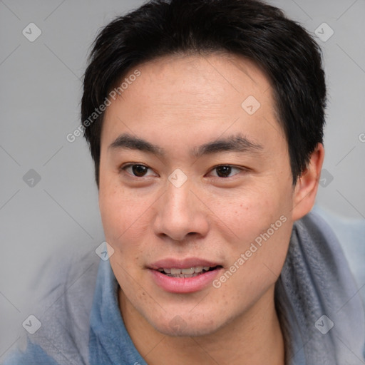 Joyful asian young-adult male with short  brown hair and brown eyes