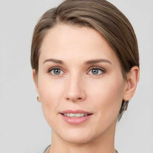 Joyful white young-adult female with short  brown hair and grey eyes