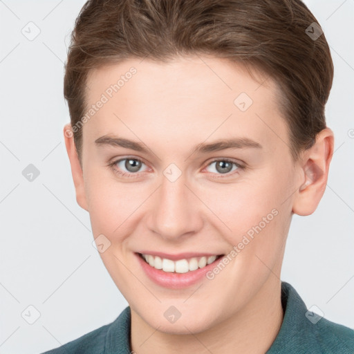 Joyful white young-adult female with short  brown hair and grey eyes