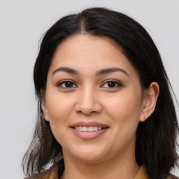 Joyful latino young-adult female with long  brown hair and brown eyes