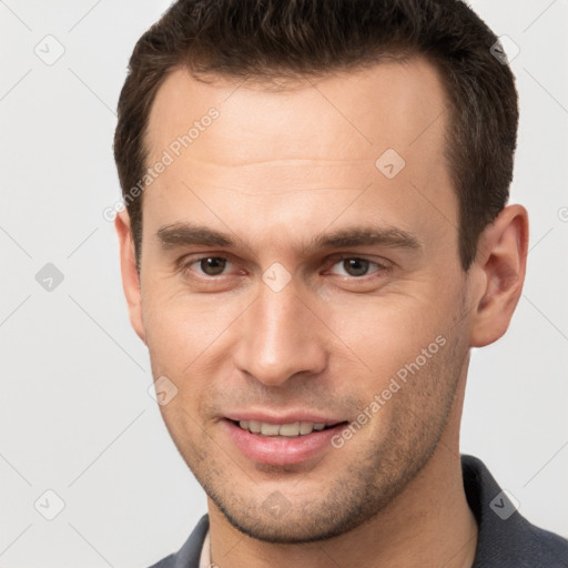 Joyful white young-adult male with short  brown hair and brown eyes