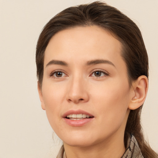 Joyful white young-adult female with long  brown hair and brown eyes