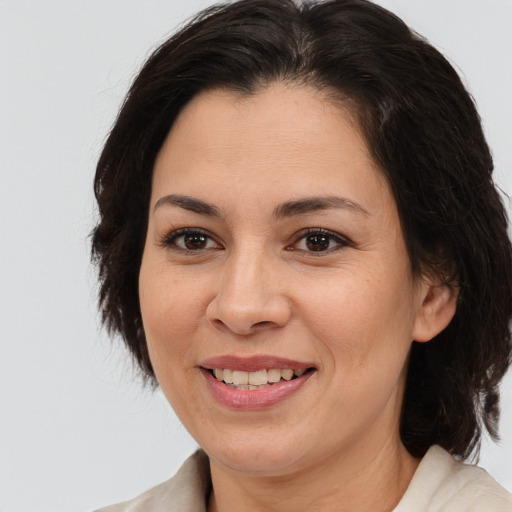 Joyful white adult female with medium  brown hair and brown eyes