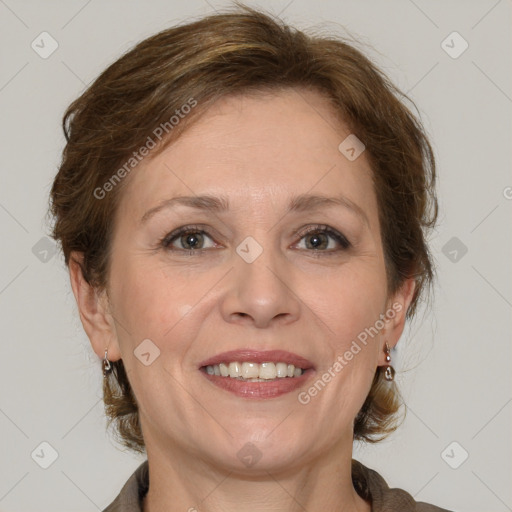 Joyful white adult female with medium  brown hair and grey eyes