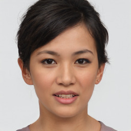 Joyful asian young-adult female with short  brown hair and brown eyes