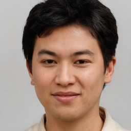 Joyful asian young-adult male with short  brown hair and brown eyes