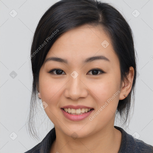 Joyful asian young-adult female with medium  black hair and brown eyes