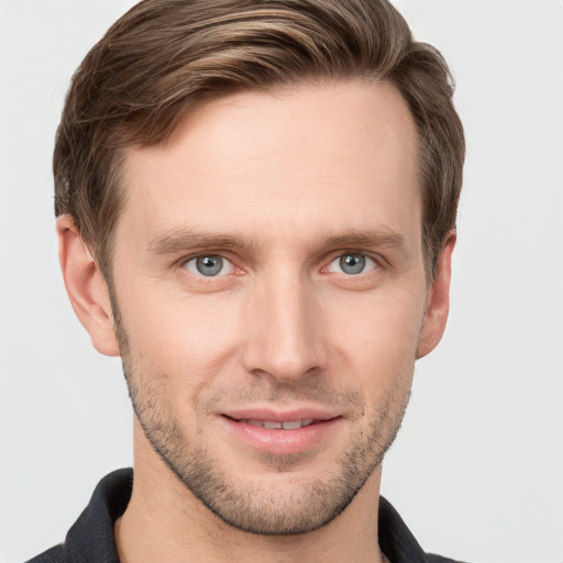 Joyful white young-adult male with short  brown hair and grey eyes