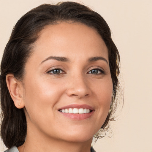 Joyful white young-adult female with medium  brown hair and brown eyes