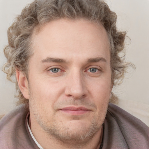 Joyful white adult male with short  brown hair and grey eyes