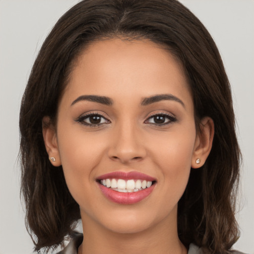 Joyful white young-adult female with long  brown hair and brown eyes