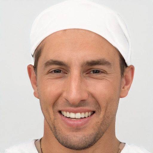 Joyful white young-adult male with short  brown hair and brown eyes