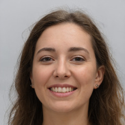 Joyful white young-adult female with long  brown hair and grey eyes