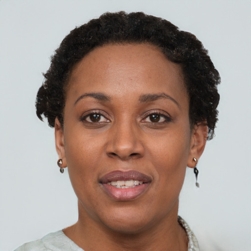 Joyful black adult female with short  brown hair and brown eyes