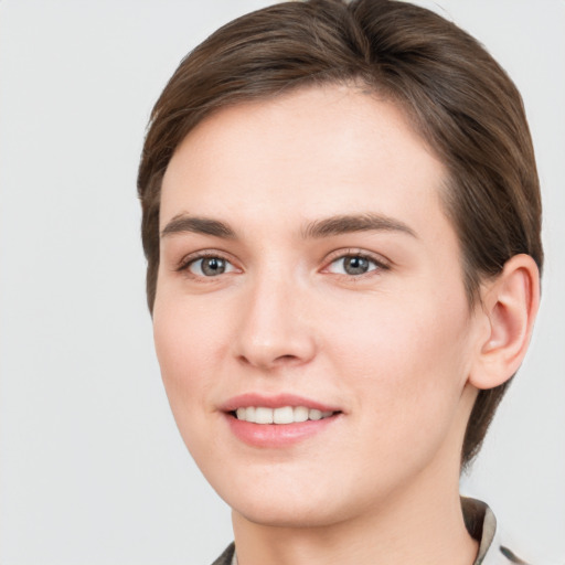 Joyful white young-adult female with medium  brown hair and grey eyes