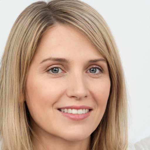 Joyful white young-adult female with long  brown hair and green eyes