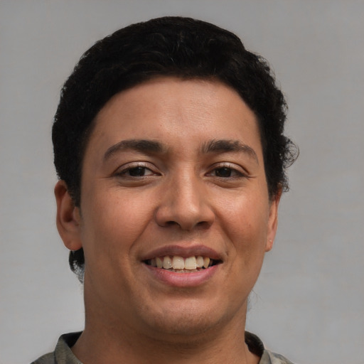 Joyful latino young-adult female with short  black hair and brown eyes