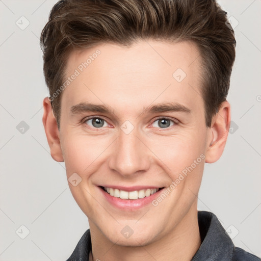 Joyful white young-adult male with short  brown hair and grey eyes