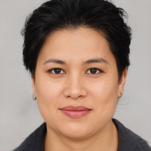 Joyful asian adult female with medium  brown hair and brown eyes