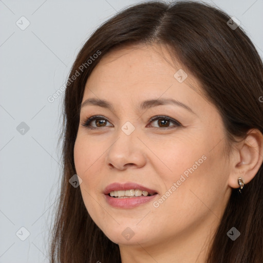 Joyful white young-adult female with long  brown hair and brown eyes