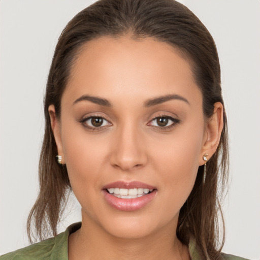 Joyful white young-adult female with long  brown hair and brown eyes