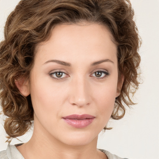 Joyful white young-adult female with medium  brown hair and green eyes