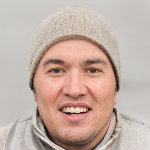 Joyful white adult male with short  black hair and grey eyes