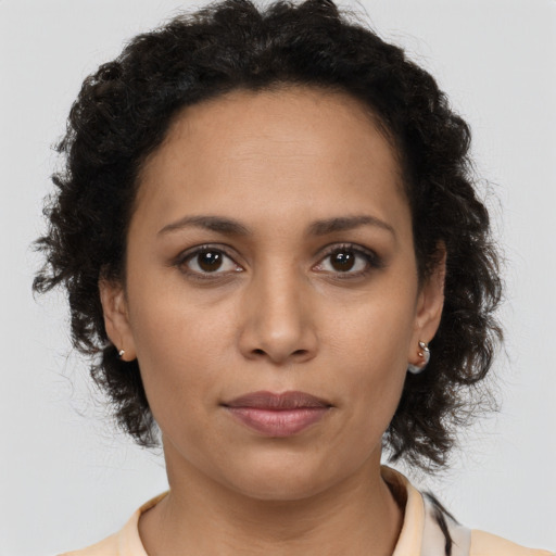 Joyful latino young-adult female with medium  brown hair and brown eyes