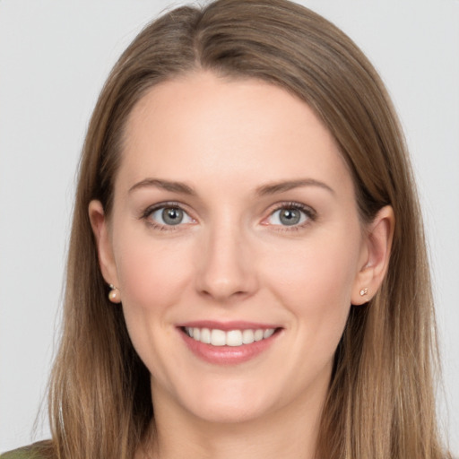 Joyful white young-adult female with long  brown hair and grey eyes