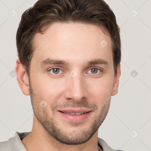 Joyful white young-adult male with short  brown hair and grey eyes