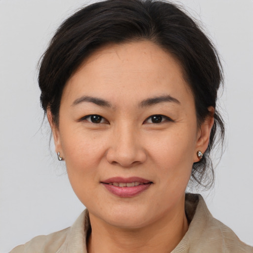 Joyful asian adult female with medium  brown hair and brown eyes