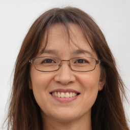 Joyful white adult female with long  brown hair and grey eyes