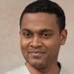 Joyful black young-adult male with short  black hair and brown eyes