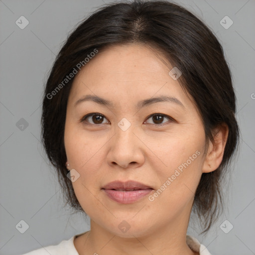 Joyful asian adult female with medium  brown hair and brown eyes