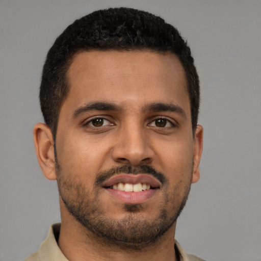 Joyful latino young-adult male with short  brown hair and brown eyes