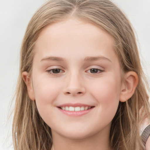 Joyful white child female with long  brown hair and grey eyes