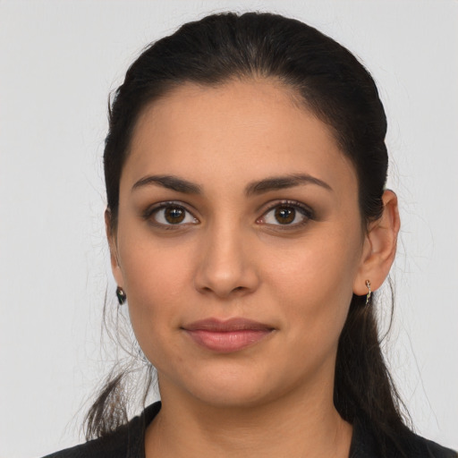 Joyful latino young-adult female with long  black hair and brown eyes