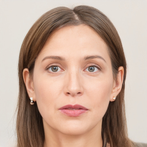 Joyful white young-adult female with long  brown hair and grey eyes