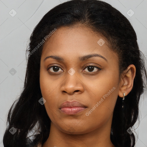 Joyful black young-adult female with long  brown hair and brown eyes