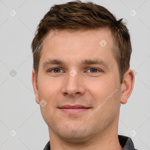 Joyful white young-adult male with short  brown hair and grey eyes