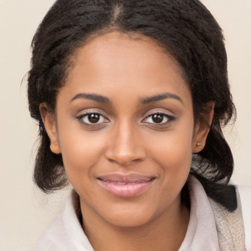 Joyful black young-adult female with medium  brown hair and brown eyes