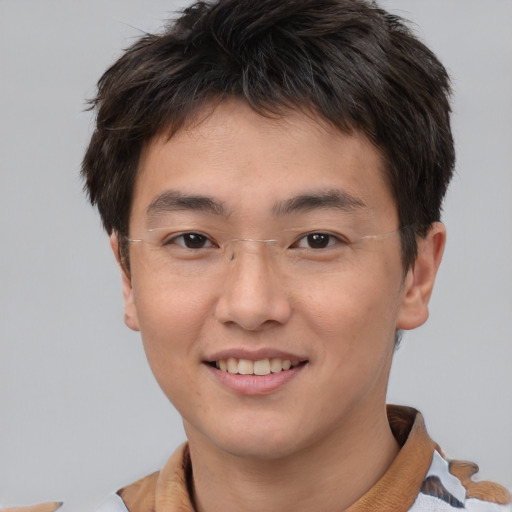 Joyful asian young-adult male with short  brown hair and brown eyes