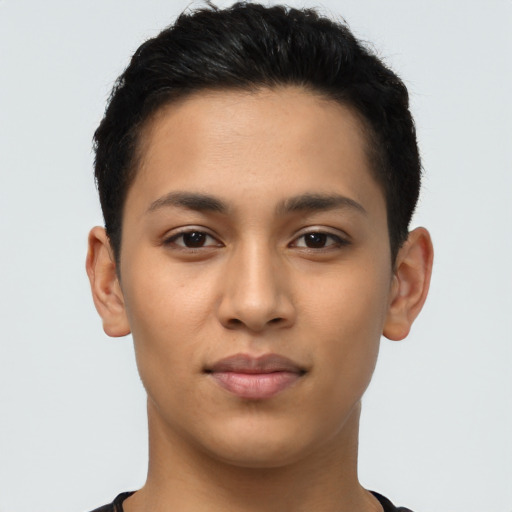 Joyful latino young-adult male with short  brown hair and brown eyes