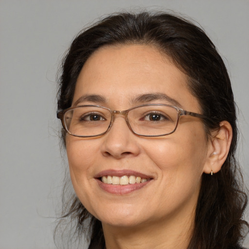 Joyful white adult female with medium  brown hair and brown eyes