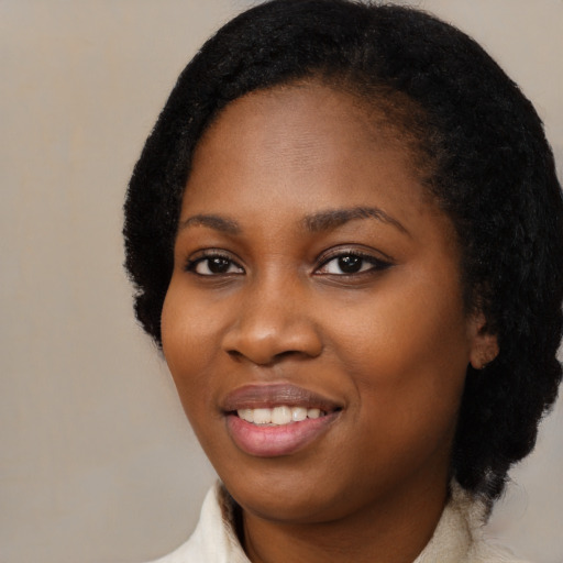 Joyful black young-adult female with medium  black hair and brown eyes