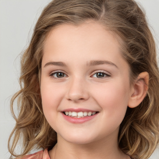 Joyful white child female with medium  brown hair and brown eyes